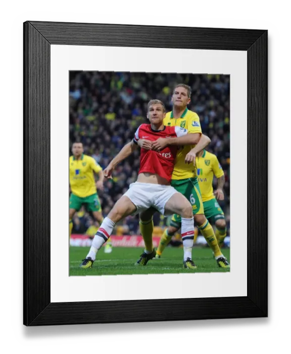 Framed Print : Arsenal vs Norwich: Mertesacker and Turner Clash in Intense Premier League Encounter (2012-13)