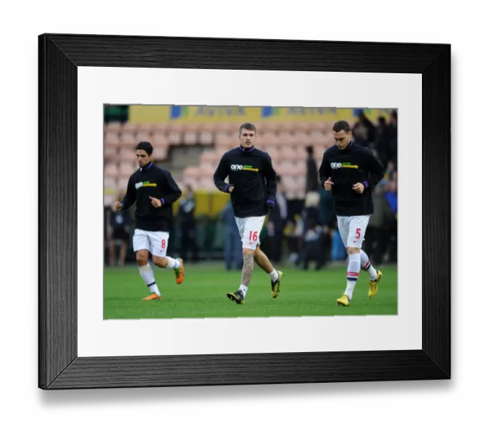 Framed Print : Arsenal Players Aaron Ramsey and Thomas Vermaelen Warm Up in Kick It Out Shirts (Norwich City vs Arsenal, 2012-13)