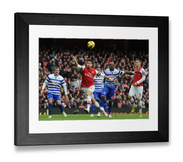 Framed Print : Giroud vs. Mbia: A Premier League Battle – Arsenal's Olivier Giroud and QPR's Stephane Mbia Clash at Emirates Stadium