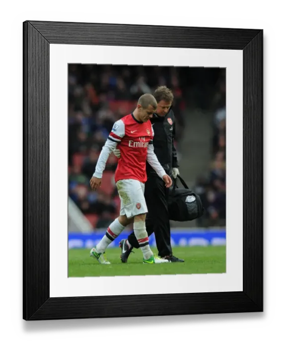 Framed Print : Arsenal's Jack Wilshere Receives Treatment from Physio Colin Lewin vs. Queens Park Rangers (2012-13)