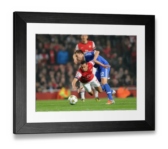 Framed Print : Arsenal's Coquelin Fouls Hoger in Champions League Clash (2012) Framed Print : Arsenal's Coquelin Fouls Hoger in Champions League Clash (2012)
