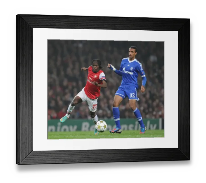 Framed Print : Gervinho vs. Joel Matip: Battle at the Emirates - Arsenal FC vs. Schalke 04, UEFA Champions League, 2012
