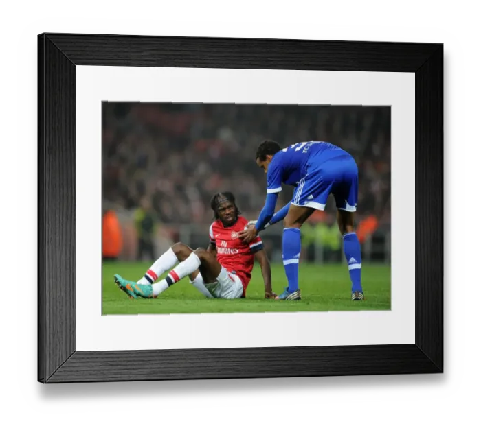 Framed Print : Arsenal's Gervinho and Schalke's Matip Share a Moment during Champions League Clash Framed Print : Arsenal's Gervinho and Schalke's Matip Share a Moment during Champions League Clash