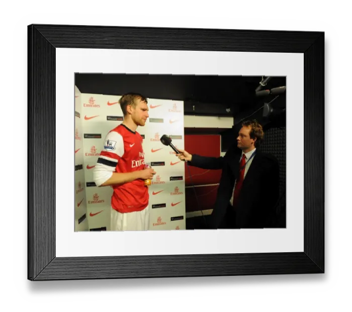 Framed Print : Per Mertesacker (Arsenal) is interviewed after the match by Josh James for Arsenal TV Framed Print : Per Mertesacker (Arsenal) is interviewed after the match by Josh James for Arsenal TV