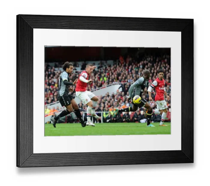 Framed Print : Podolski Scores Past Gallas: Arsenal's Thrilling Victory Over Tottenham in the Premier League 2012-13