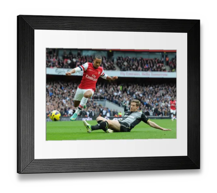 Framed Print : Theo Walcott vs Jan Vertonghen: Intense Battle in the Arsenal v Tottenham Rivalry