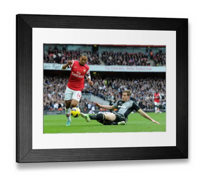 Framed Print : Theo Walcott vs Jan Vertonghen: A Fierce Encounter in the Arsenal-Tottenham Rivalry