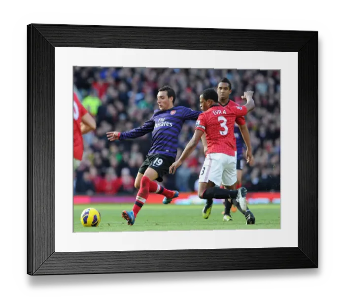 Framed Print : Santi Cazorla (Arsenal) Patrice Evra (Man Utd). Manchester United 2: 1 Arsenal. Barclays Framed Print : Santi Cazorla (Arsenal) Patrice Evra (Man Utd). Manchester United 2: 1 Arsenal. Barclays