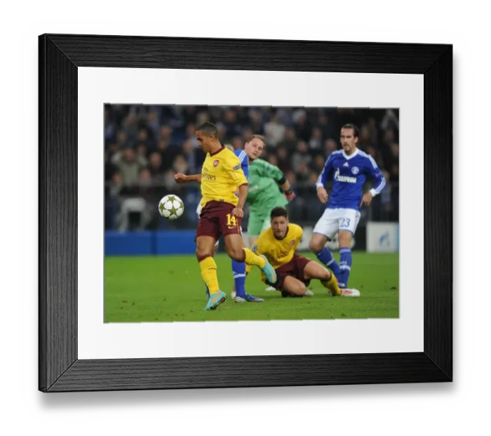 Framed Print : Theo Walcott's Historic Goal: Beats Benedikt Howedes for Arsenal in the 2012-13 UEFA Champions League