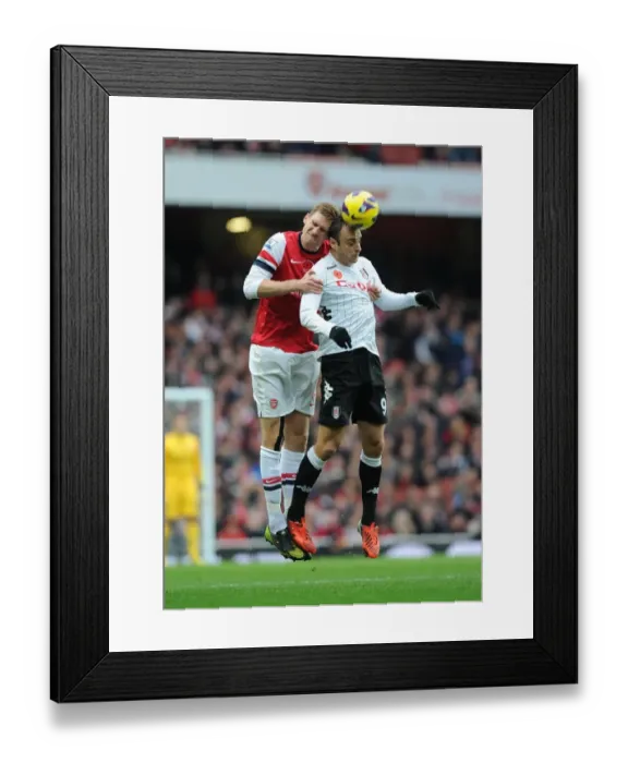 Framed Print : Arsenal vs. Fulham: Per Mertesacker vs. Dimitar Berbatov - Premier League Clash at Emirates Stadium (2012-13) Framed Print : Arsenal vs. Fulham: Per Mertesacker vs. Dimitar Berbatov - Premier League Clash at Emirates Stadium (2012-13)