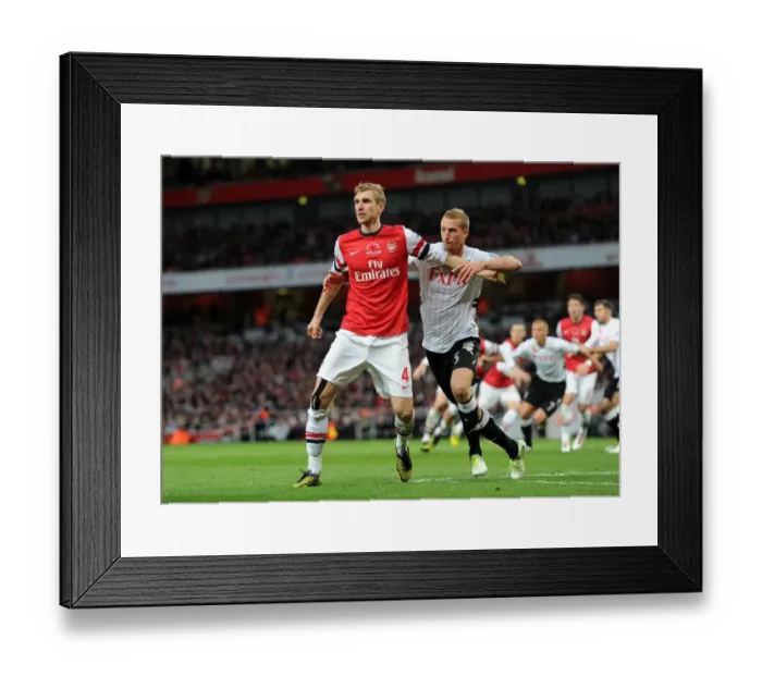 Framed Print : Arsenal's Mertesacker vs. Fulham's Hangeland: A Premier League Face-Off