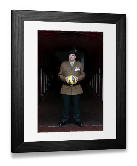 Framed Print : A Soldier bring on the matchball. Arsenal 3: 3 Fulham. Barclays Premier League. Emirates Stadium