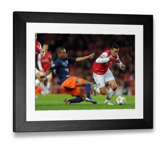 Framed Print : Arsenal's Coquelin Clashes with Montpellier's Marveaux in Champions League Showdown Framed Print : Arsenal's Coquelin Clashes with Montpellier's Marveaux in Champions League Showdown