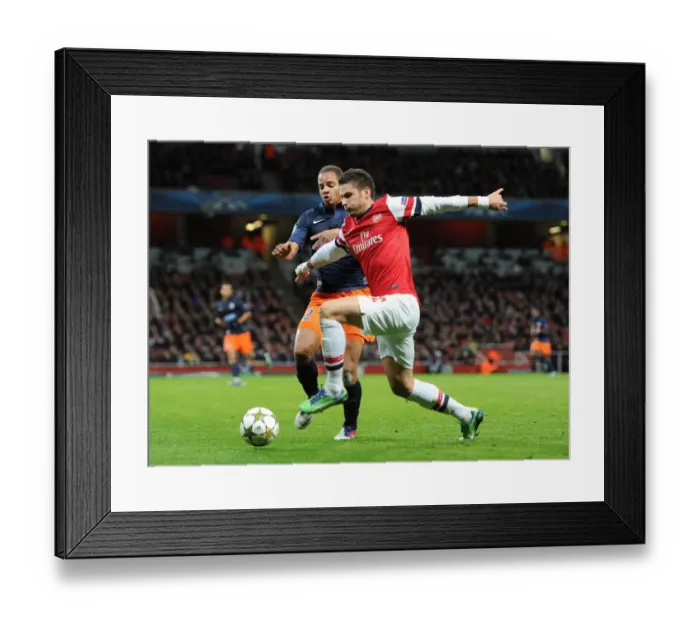 Framed Print : Olivier Giroud (Arsenal) Daniel Congre (Montpellier). Arsenal 2: 0 Montpellier. UEFA Framed Print : Olivier Giroud (Arsenal) Daniel Congre (Montpellier). Arsenal 2: 0 Montpellier. UEFA