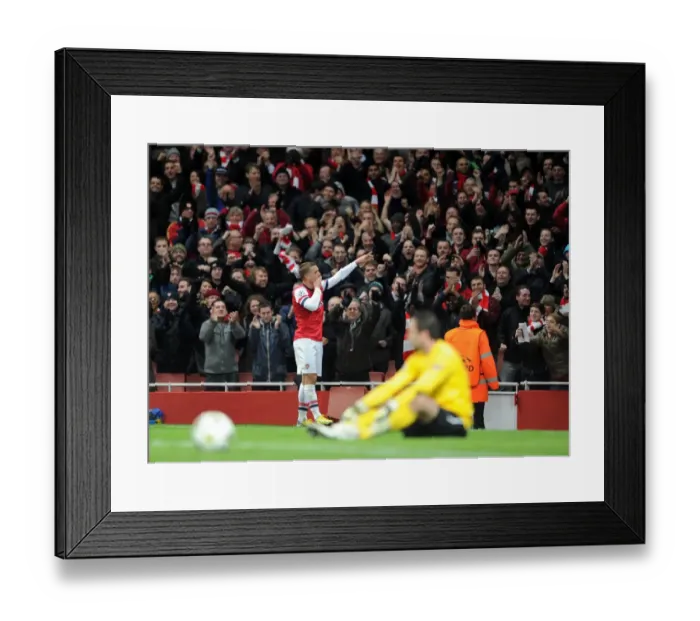 Framed Print : Lukas Podolski celebrates scoring Arsenals 2nd goal. Arsenal 2: 0 Montpellier. UEFA