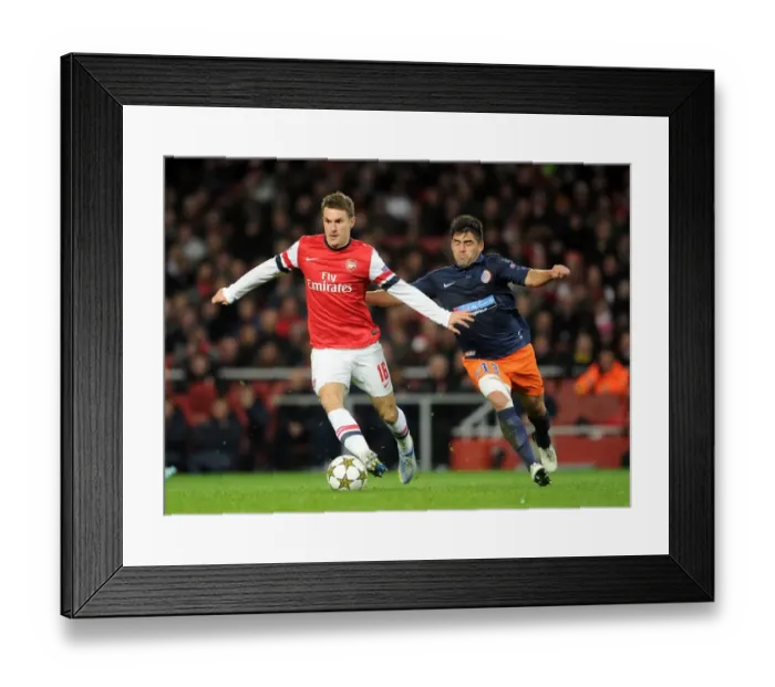 Framed Print : Arsenal's Aaron Ramsey Faces Off Against Montpellier's Marco Estrada in 2012-13 Champions League Clash