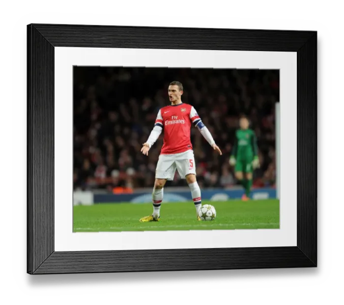 Framed Print : Thomas Vermaelen: Arsenal's Unyielding Defender in Action against Montpellier, UEFA Champions League 2012-13