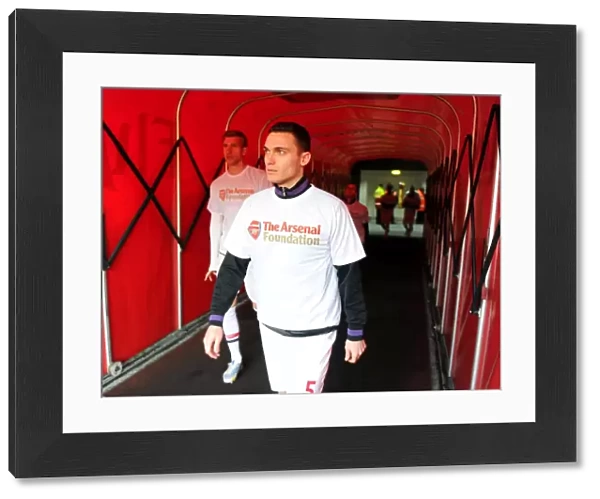 Thomas Vermaelen (Arsenal) walks out to warm up in his Arsenal Foundation t shirt