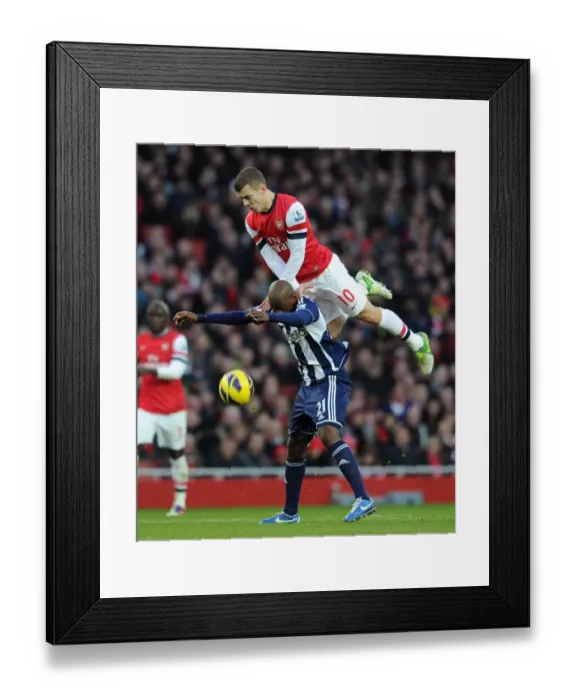 Framed Print : Arsenal's Jack Wilshere vs. West Brom's Youssouf Mulumbu: A Battle for the Ball, Arsenal v West Bromwich Albion, Premier League 2012-13