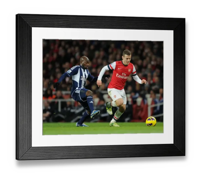 Framed Print : Jack Wilshere vs Youssouf Mulumbu: Intense Battle at Emirates Stadium (Arsenal v West Bromwich Albion 2012-13) Framed Print : Jack Wilshere vs Youssouf Mulumbu: Intense Battle at Emirates Stadium (Arsenal v West Bromwich Albion 2012-13)