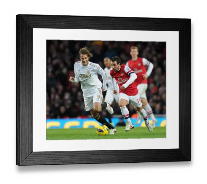 Framed Print : Arsenal's Santi Cazorla Clashes with Swansea's Miguel Michu in Premier League Showdown (2012-13)