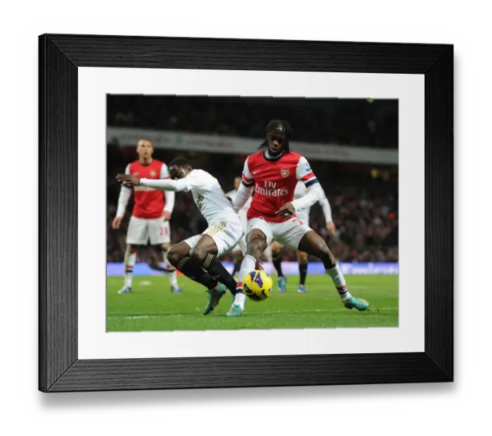 Framed Print : Gervinho vs. Nathan Dyer: Intense Battle at the Emirates - Arsenal v Swansea City, Premier League (2012-13) Framed Print : Gervinho vs. Nathan Dyer: Intense Battle at the Emirates - Arsenal v Swansea City, Premier League (2012-13)