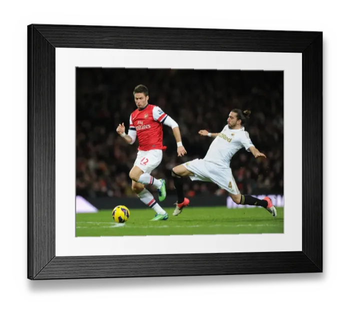 Framed Print : Arsenal's Olivier Giroud Outmaneuvers Swansea's Chico Flores in Premier League Clash (December 2012) Framed Print : Arsenal's Olivier Giroud Outmaneuvers Swansea's Chico Flores in Premier League Clash (December 2012)