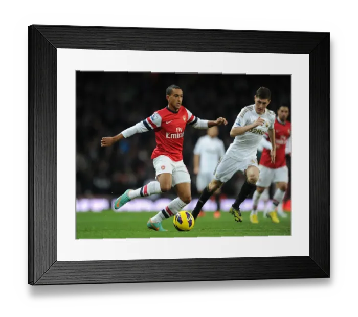 Framed Print : Arsenal's Theo Walcott Faces Off Against Swansea's Ben Davies in Premier League Clash (2012-13) Framed Print : Arsenal's Theo Walcott Faces Off Against Swansea's Ben Davies in Premier League Clash (2012-13)