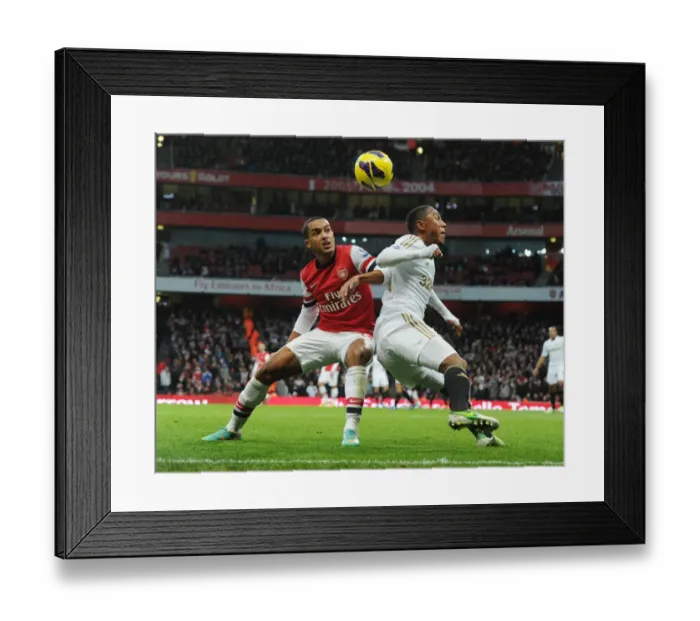 Framed Print : Theo Walcott vs. Jonathan De Guzman: Intense Battle at Arsenal v Swansea (2012-13) Framed Print : Theo Walcott vs. Jonathan De Guzman: Intense Battle at Arsenal v Swansea (2012-13)