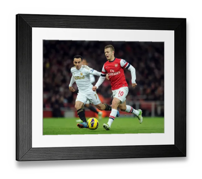 Framed Print : Arsenal's Jack Wilshere Clashes with Swansea's Leon Britton during the 2012-13 Premier League Match