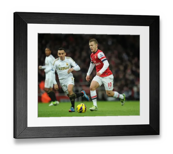 Framed Print : Intense Rivalry: Jack Wilshere vs Leon Britton Clash in the 2012-13 Premier League Framed Print : Intense Rivalry: Jack Wilshere vs Leon Britton Clash in the 2012-13 Premier League