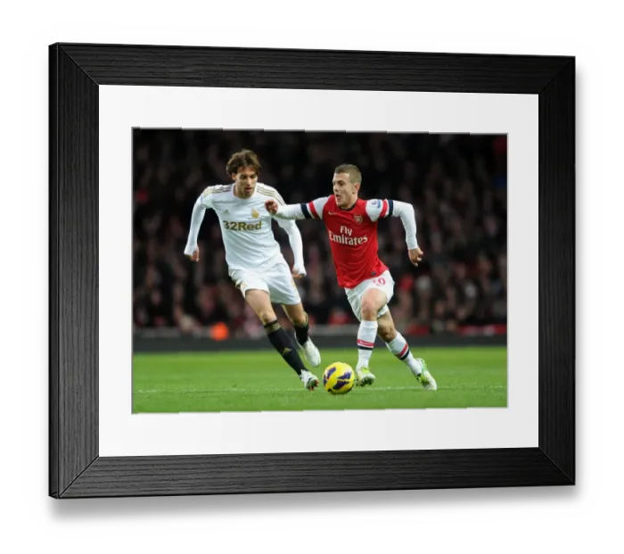 Framed Print : Arsenal's Jack Wilshere Clashes with Swansea's Miguel Michu in Premier League Showdown (2012-13) Framed Print : Arsenal's Jack Wilshere Clashes with Swansea's Miguel Michu in Premier League Showdown (2012-13)