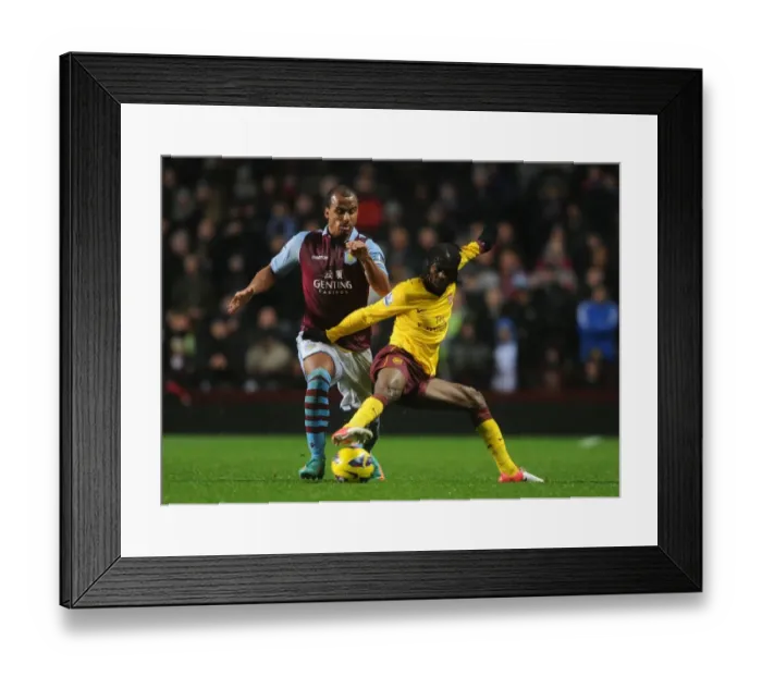 Framed Print : Gervinho vs Agbonlahor: Intense Battle in Aston Villa vs Arsenal Premier League Clash