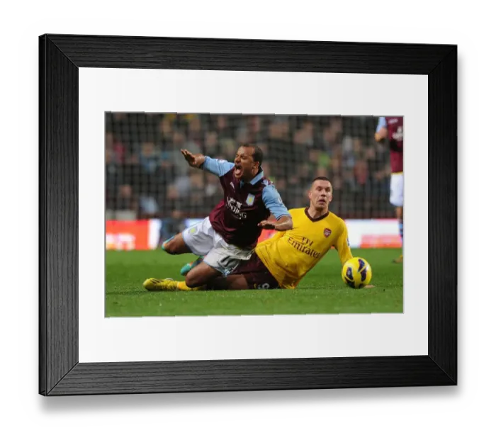 Framed Print : Podolski Tackles Agbonlahor: Aston Villa vs Arsenal, Premier League 2012-13