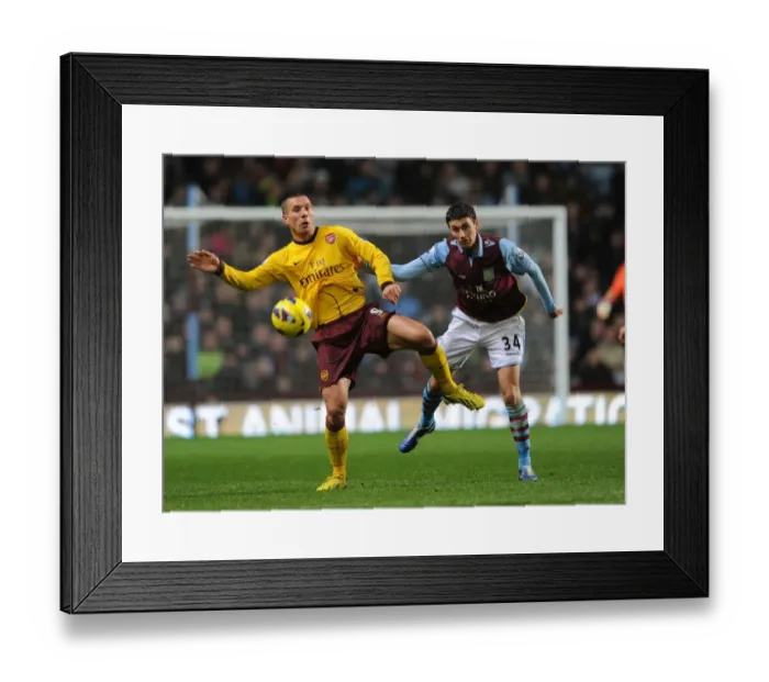 Framed Print : Podolski vs. Lowton: A Battle at Villa Park - Arsenal vs. Aston Villa, Premier League 2012-13 Framed Print : Podolski vs. Lowton: A Battle at Villa Park - Arsenal vs. Aston Villa, Premier League 2012-13