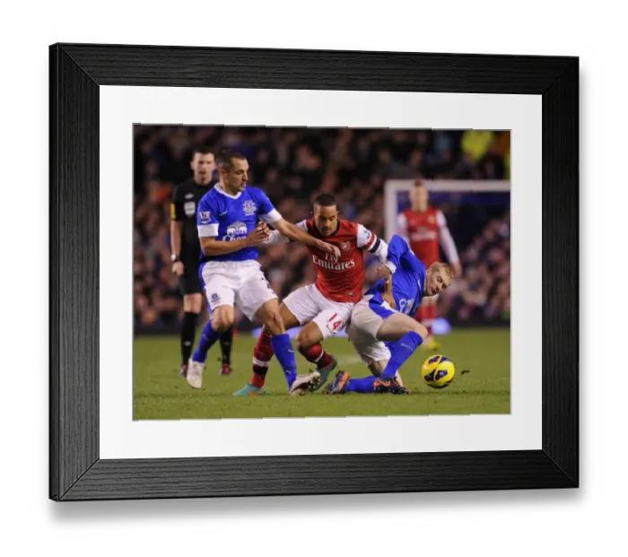 Framed Print : Theo Walcott Faces Off Against Everton's Tony Hibbert and Leon Osman in Premier League Showdown