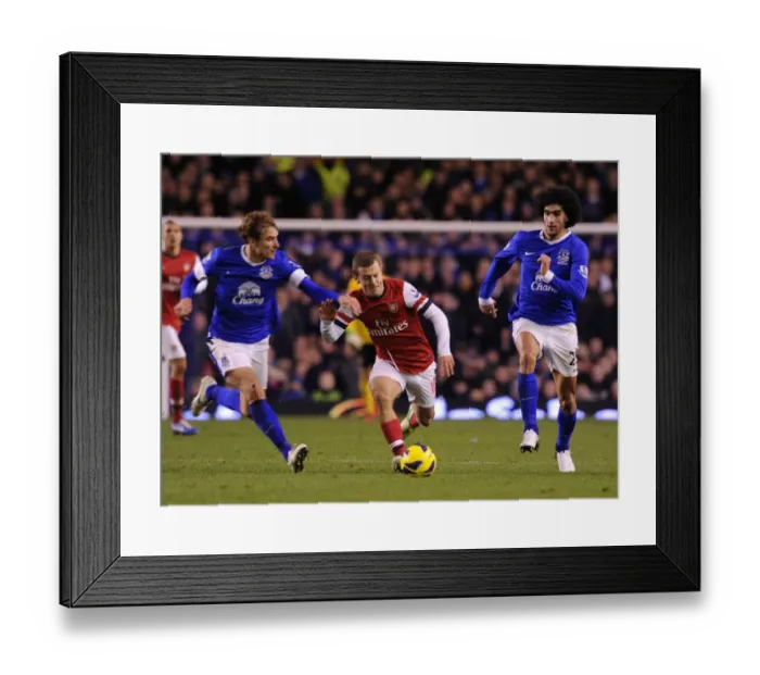 Framed Print : Jack Wilshere Surges Past Nikica Jelavic and Marouane Fellaini in Everton vs Arsenal Premier League Clash Framed Print : Jack Wilshere Surges Past Nikica Jelavic and Marouane Fellaini in Everton vs Arsenal Premier League Clash