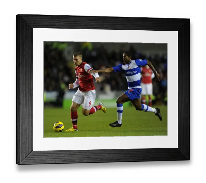 Framed Print : Podolski vs. Leigertwood: Battle at the Madejski Stadium - Reading v Arsenal, Premier League 2012-13