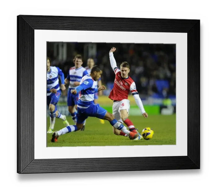 Framed Print : Arsenal's Aaron Ramsey Fends Off Reading's Adrian Mariappa Framed Print : Arsenal's Aaron Ramsey Fends Off Reading's Adrian Mariappa
