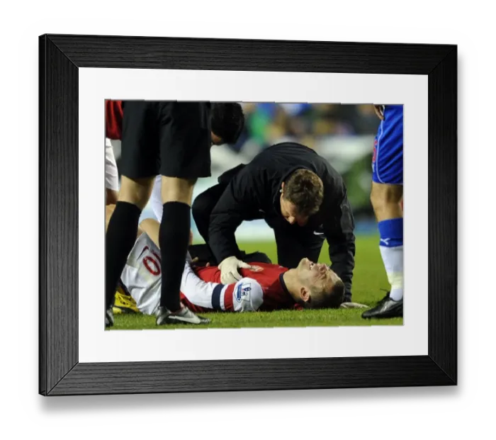 Framed Print : Jack Wilshere Receives Treatment from Arsenal Physio Colin Lewin during Reading vs Arsenal (2012-13)