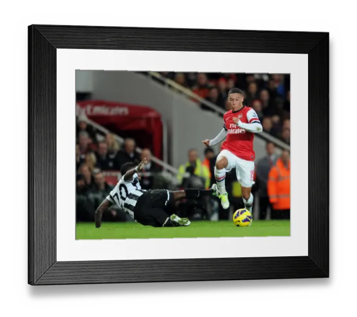 Framed Print : Alex Oxlade-Chamberlain Outmaneuvers Gael Bigirimana in Arsenal's Victory over Newcastle United Framed Print : Alex Oxlade-Chamberlain Outmaneuvers Gael Bigirimana in Arsenal's Victory over Newcastle United