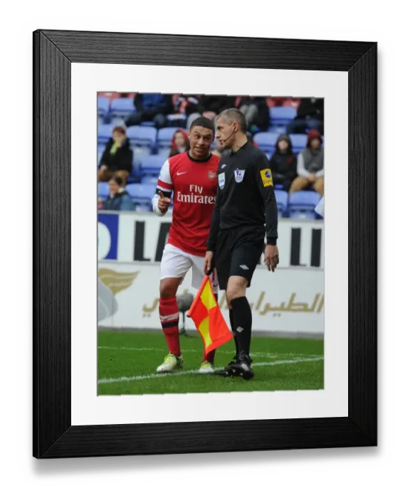 Framed Print : Alex Oxlade-Chamberlain's Playful Moment: Wigan Athletic vs. Arsenal, Premier League 2012-13