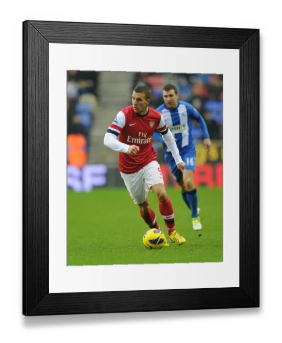 Framed Print : Lukas Podolski in Action: Wigan Athletic vs. Arsenal, Premier League 2012-13