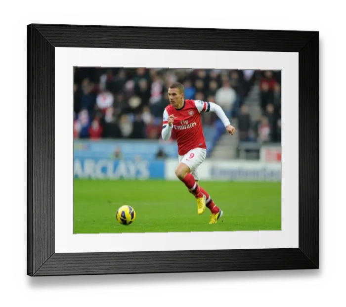 Framed Print : Lukas Podolski (Arsenal). Wigan Athletic 0: 1 Arsenal. Barclays Premier League. The DW Stadium Framed Print : Lukas Podolski (Arsenal). Wigan Athletic 0: 1 Arsenal. Barclays Premier League. The DW Stadium