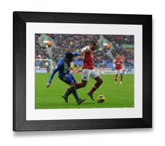 Framed Print : Theo Walcott Fouled by Jean Beausejour: Arsenal vs. Wigan Athletic, Premier League (2012-13)