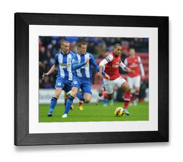 Framed Print : Theo Walcott vs. James McCarthy: Intense Battle in Wigan Athletic vs. Arsenal (2012-13) Framed Print : Theo Walcott vs. James McCarthy: Intense Battle in Wigan Athletic vs. Arsenal (2012-13)
