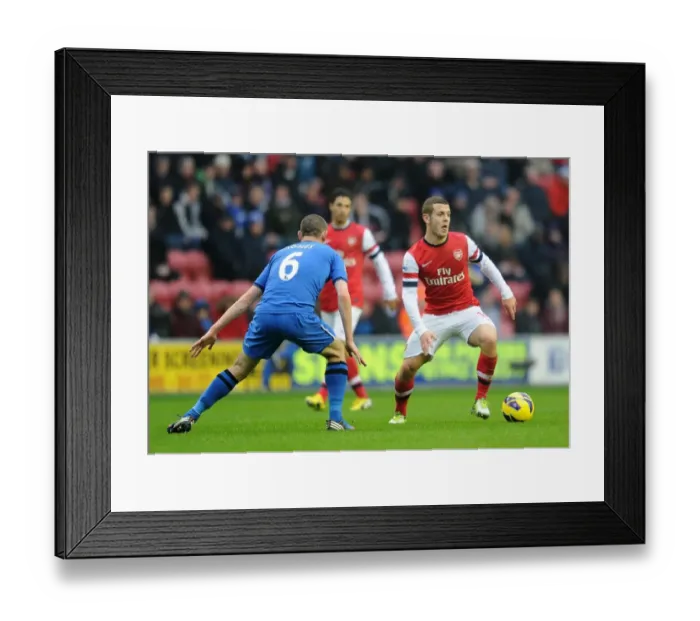 Framed Print : Jack Wilshere vs. David Jones: Intense Battle in Wigan Athletic vs. Arsenal (2012-13 Premier League)