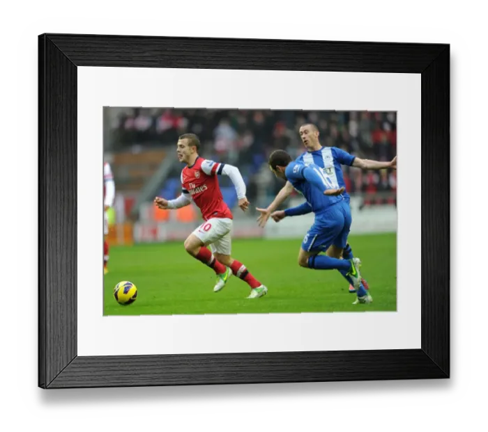 Framed Print : Jack Wilshere Darts Past David Jones and James McArthur (Wigan Athletic vs Arsenal, 2012-13)