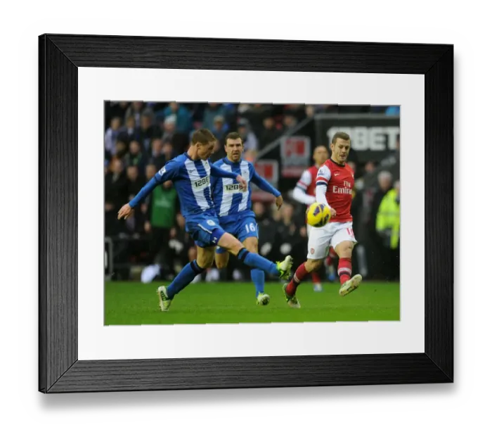 Framed Print : Jack Wilshere vs. James McCarthy: Intense Battle in Wigan Athletic vs. Arsenal (2012-13 Premier League)