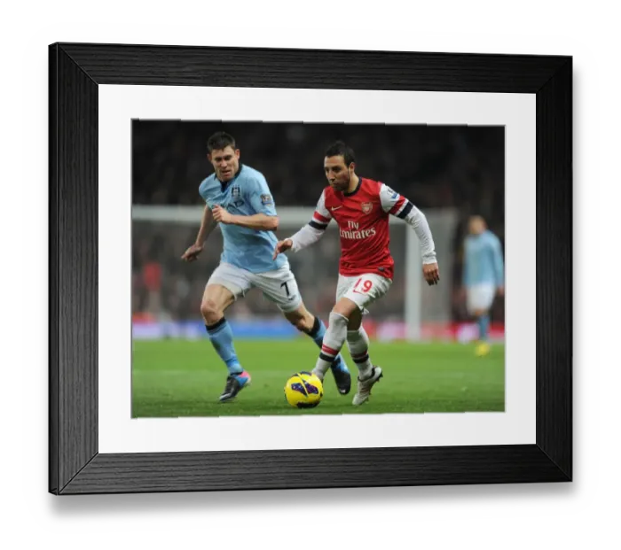 Framed Print : Arsenal's Santi Cazorla Clashes with Manchester City's James Milner in Premier League Showdown Framed Print : Arsenal's Santi Cazorla Clashes with Manchester City's James Milner in Premier League Showdown